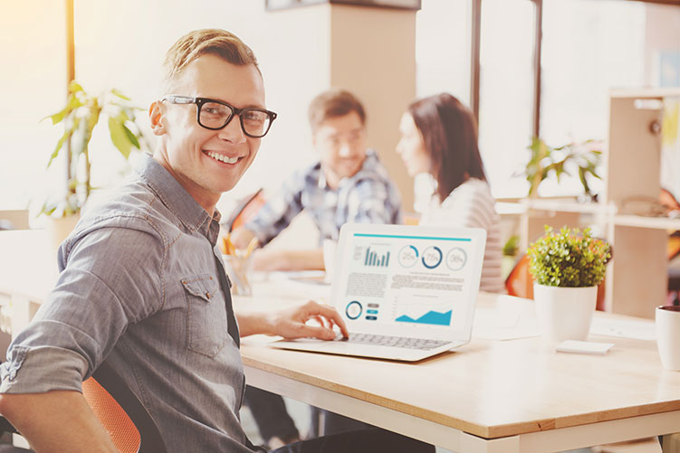 man at computer wearing glasses